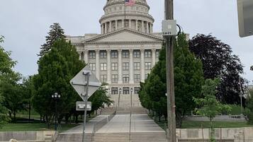 A large, classical building with a prominent dome and columns, likely a government or state capitol.