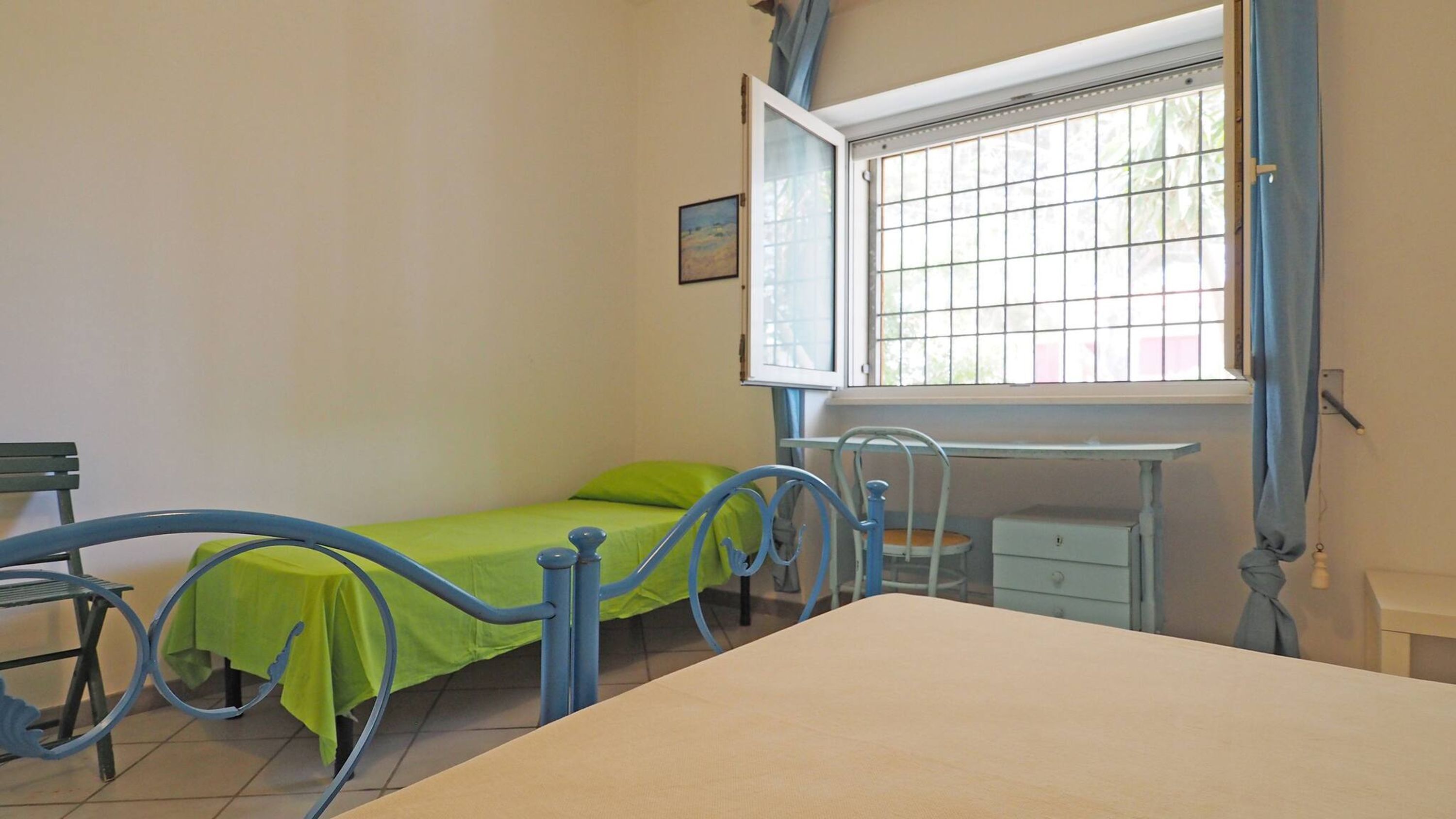 Une chambre à coucher avec un lit, un bureau et une fenêtre.