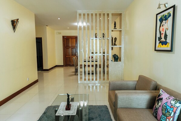 Deluxe Apartment, 2 Bedrooms, Balcony, City View | Living area | Flat-screen TV