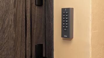 A door with a keypad lock and a keyhole.