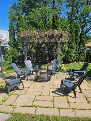 A patio area with outdoor furniture, a fire pit, and a pergola covered in greenery. - F.R.I.E.N.D.S inspired studio in beautiful Barrington with WiFi, AC (Barrington)