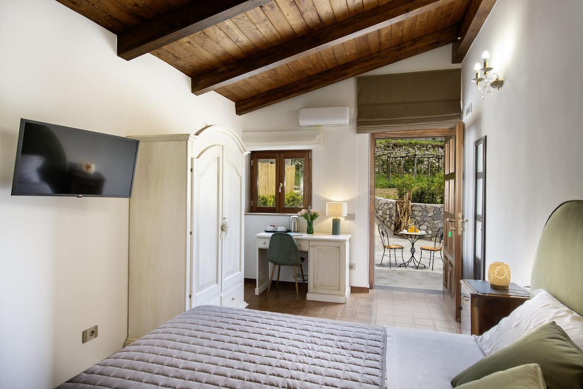 Quadruple Room, Garden View | In-room safe, desk, laptop workspace, blackout drapes