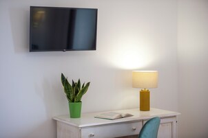 Deluxe Quadruple Room, Sea View | In-room safe, desk, laptop workspace, blackout drapes