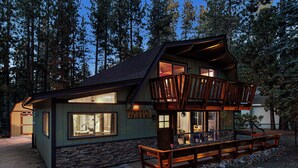 A two-story cabin with a stone foundation, large windows, and a wooden deck. - Summit's Trident, Spa, Game Room, Snow Summit (Big Bear Lake)