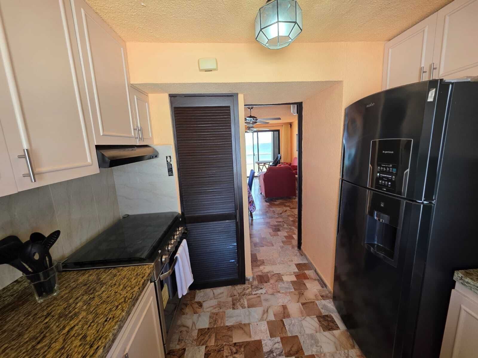 Apartamento família, vista para a praia | Cozinha privada