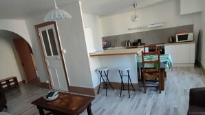 A compact living space with a kitchen, dining area, and a small seating area.