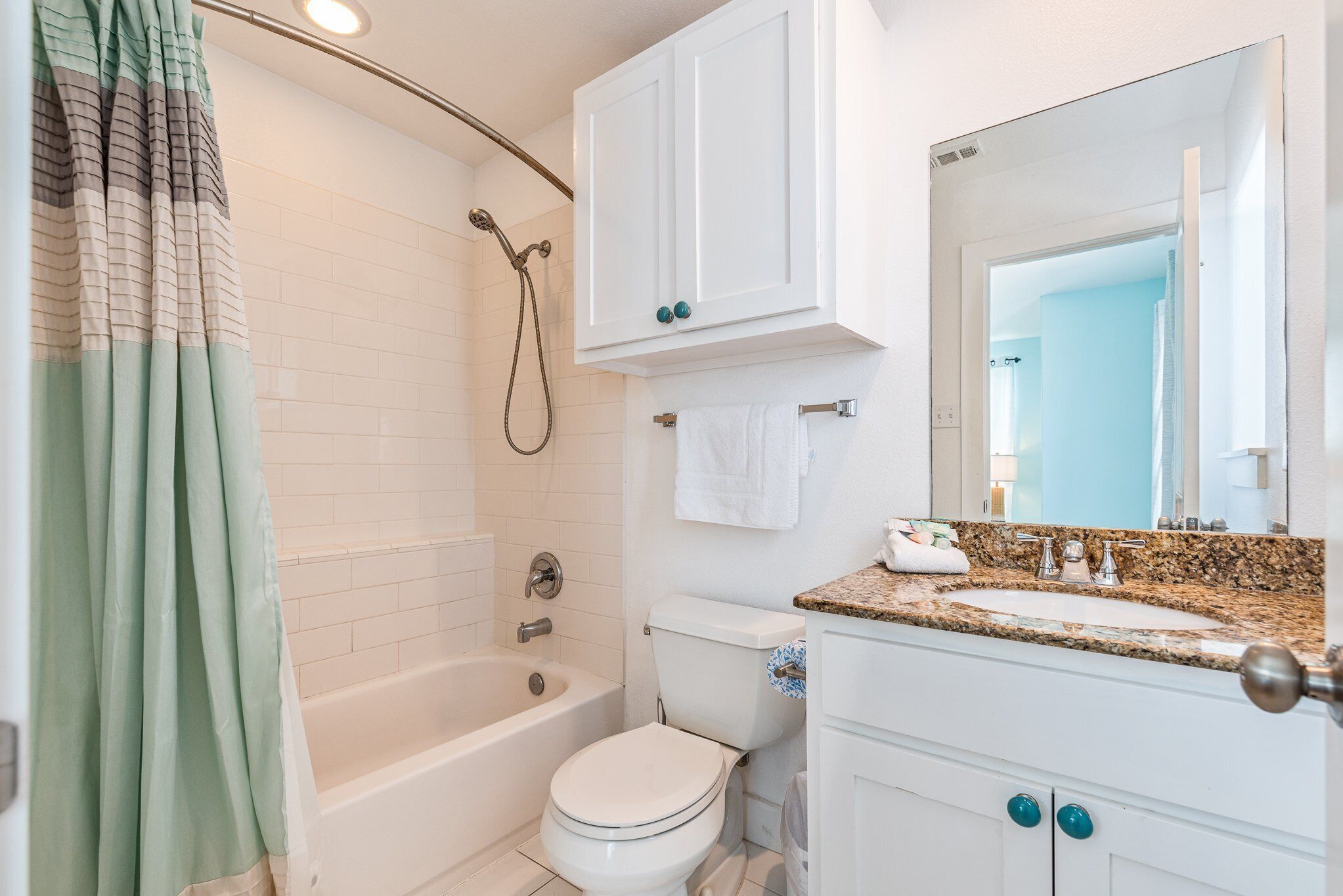 A bathroom with a bathtub, toilet, and sink.