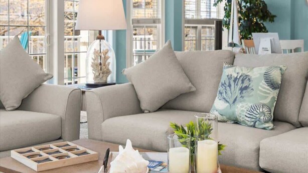 A living room with two sofas, a coffee table, and a lamp. - Seaside Escape Mansion (Ocean City)