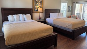 Two double beds with wooden headboards, a painting above the beds, and a window with blinds. - Luxury Lodging, Lakefront View,  2 Queen Beds w/Private Bath, Private Patio. (Elizabethtown)