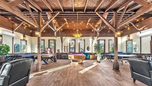 A spacious indoor area with wooden floors, a pool table, and multiple seating areas. - Tranquil Retreat W/hot-tub 10-mins to Downtown! (Fredericksburg)