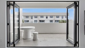 A modern interior with a sliding glass door leading to an outdoor balcony.