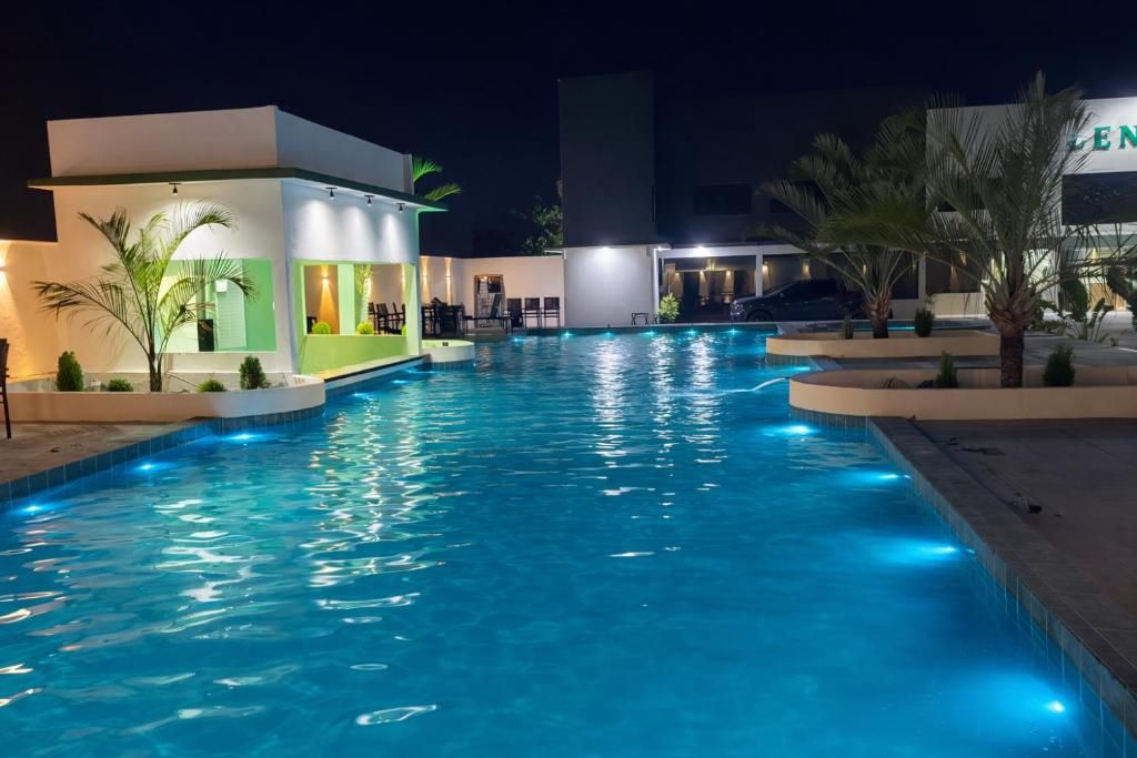A swimming pool with a modern building in the background.