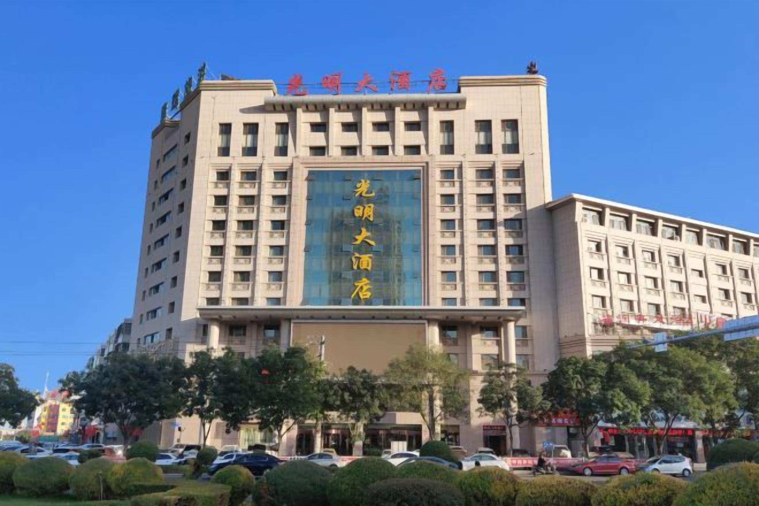 A multi-story hotel with a prominent sign and a large entrance.