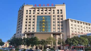 A multi-story hotel with a prominent sign and a large entrance.