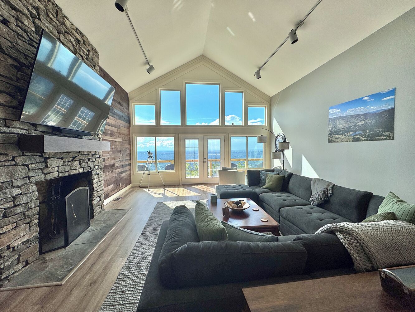 The Living Room has beautiful views, a huge sectional and two chairs, & 86" TV