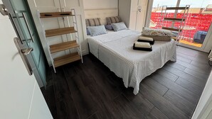 A bedroom with a bed, a wardrobe, a ladder, and a large window. - HOUSE IN MASNOU NEXT TO BEACH AND TRAIN (El Masnou)