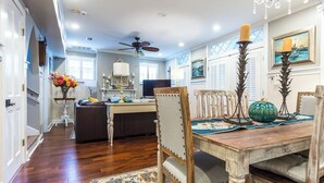 A dining area with a wooden table, chairs, and a chandelier. - Charming 3-bedroom cottage in Oakleigh Historical District in downtown Mobile (Mobile)