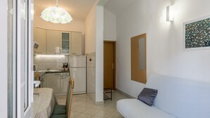 A compact living space with a kitchenette, a dining area, and a seating area. - Adriatic Island Sea View -Cmfrt 1Bedroom/TerraceA2 (Bol)