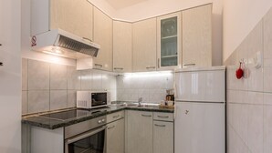 A compact kitchen with a microwave, oven, and refrigerator. - Adriatic Island Sea View -Cmfrt 1Bedroom/TerraceA2 (Bol)
