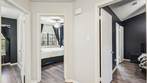 A bedroom with a bed, a ceiling fan, and a window. - Cowboy Oasis !King Bed with WiFi by Domain (Austin)