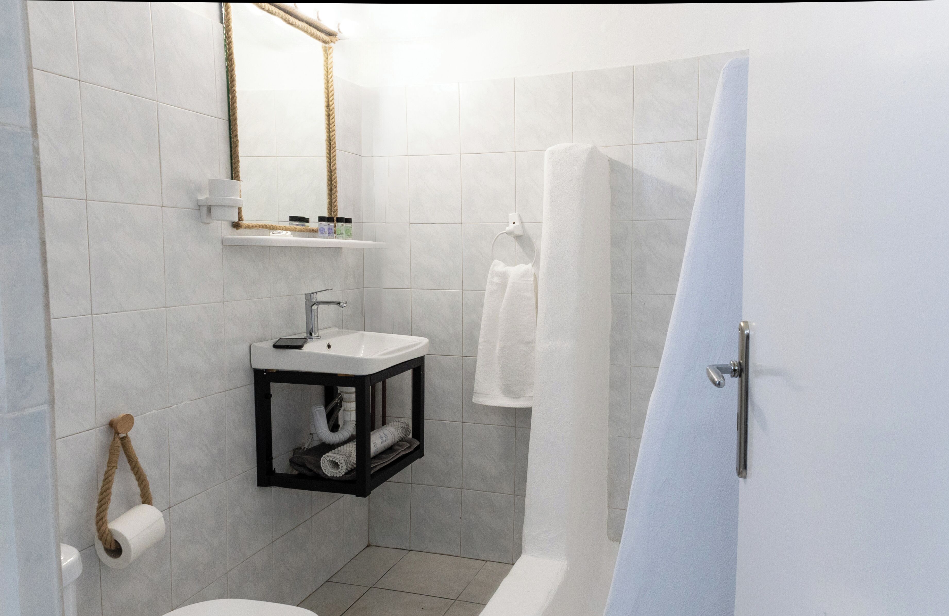A modern bathroom with a toilet, sink, and shower.