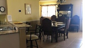 A dining area with a central island, chairs, and a chandelier. - Cisky Park Leesburg over looking Lake Harris (Leesburg)