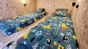 A room with two beds, each with a floral and animal print bedspread. - House sleeps 4 (Saint-Léger-sous-Brienne)