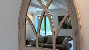 A mirror with a diamond pattern frame mounted on a wall.