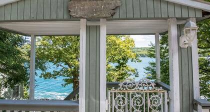 Cozy Lakefront Cottage with Porches, Dock, and Lake Views
