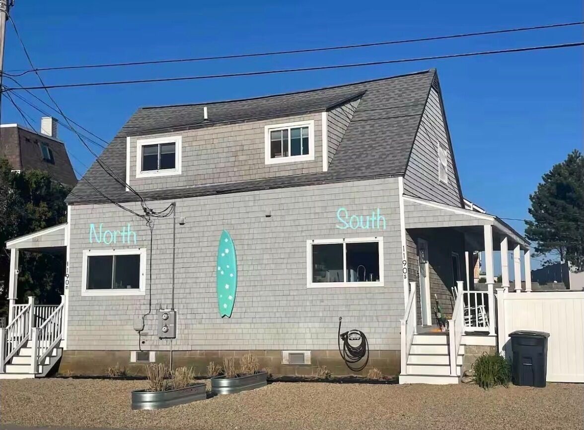 A two-story building with "North" and "South" signs on the side.