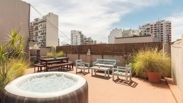 A rooftop terrace with a hot tub, wooden furniture, and potted plants. - PH IN PALERMO SOHO WITH TWO SPECTACULAR TERRACES BBQ AND FAMILY ROOM (Buenos Aires)