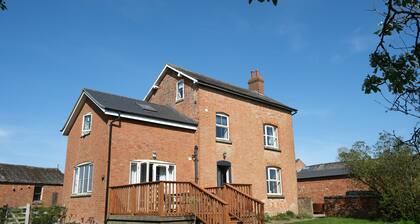 Historic cottage with a large scenic garden, located on a working farm
