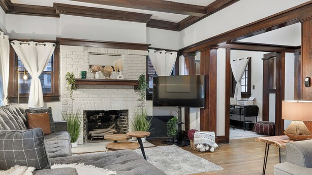 A living room with a fireplace, a television, and a sofa. - NEW! Southern Retreat w/Pool, BBQ & Game Room (Birmingham)