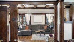 A living room with a sectional sofa, a small coffee table, and a fireplace. - NEW! Southern Retreat w/Pool, BBQ & Game Room (Birmingham)