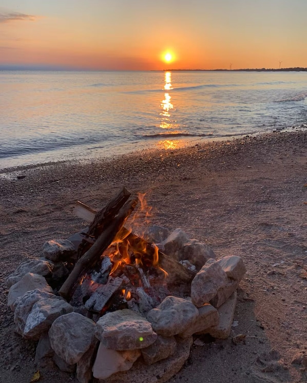 A beach scene with a campfire at sunset. - Sunsets and Fires (Dunnville)