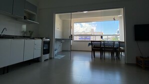 Une cuisine moderne avec des meubles blancs et un coin repas comprenant une table et des chaises.
