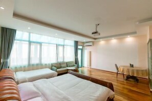 A hotel room with two beds, a sofa, a small table, and a window with curtains. - Runshang Hotel (Harbin Engineering University) (Harbin)
