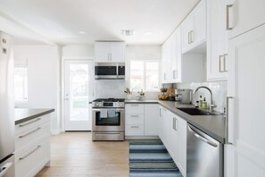 Fridge, microwave, oven, stovetop - The Trendy Tricycle | Stylish 4BR in Central Phx (Phoenix)