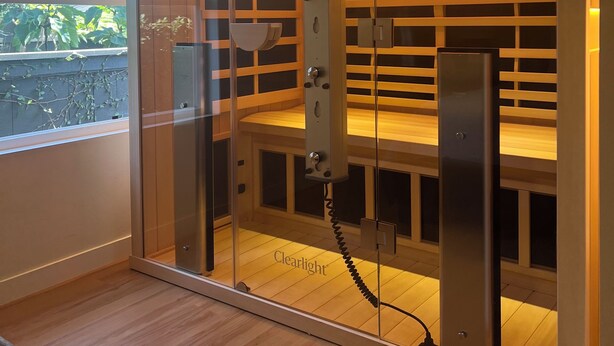 A modern room with a glass partition, wooden shelves, and a control panel. - Stylish, Modern 3-Level House-Yard-Patio-Balcony-Sauna- Blocks to Beaches - OB  (San Diego)