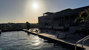 A rooftop pool with clear water, sun loungers, and a covered seating area. - Tuk Tulum by Marea (Tulum)