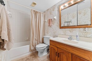 Ein Badezimmer mit Badewanne, Toilette und Waschbecken.