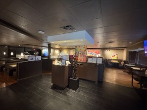 A modern hotel lobby with a reception desk, seating areas, and artwork on the walls. - art infiniti hotel (maple ridge)