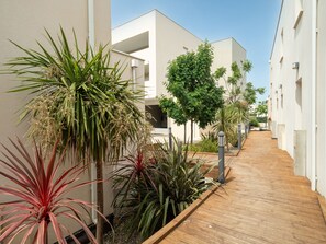 Residents can enjoy communal living with access to a central walkway and balconies.