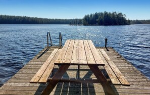 A wooden dock extending into a lake with a picnic table in the center. - Nice home in Vittsjö with sauna (Vittsjö)