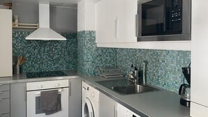 A kitchen with a microwave, oven, washing machine, sink, and a dish rack. - 1 bedroom stunning home in Mullsjö (Mullsjö)