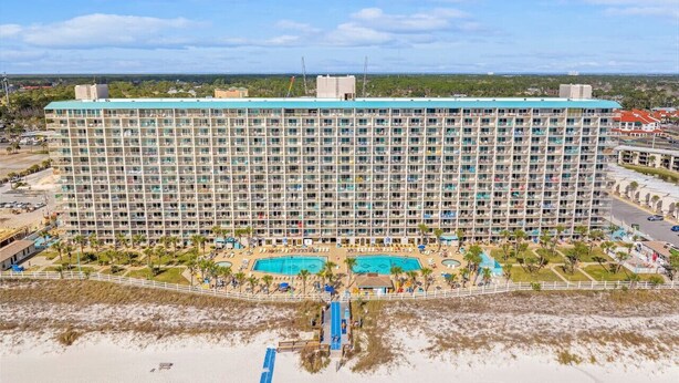A large hotel with multiple floors, a pool area, and a beachside location. - Oceanfront, 2nd Floor, Sea View, 2 Pools (Panama City Beach)