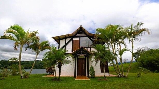 A two-story building with a gabled roof and a central entrance.
