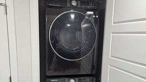 Un cuarto de lavandería con dos lavadoras apiladas.