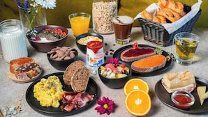 A breakfast spread with various foods and drinks. - B&B HOTEL Lisieux Parc des Expositions (Lisieux)