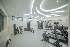 A modern gym with various exercise equipment, including treadmills and weight machines.